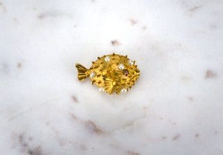 Puffer Fish Brooch Pin. Designer: Napier Period: 1950s Dimensions: 1.5” Material: gold plated, faux pearls Condition: Excellent  While real puffer fish are deadly if eaten incorrectly, we suggest wearing this spiky little gem on your collar, if only to keep toxic people away from you. Available at Fonfrege.com