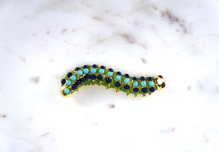 Enamel Caterpillar Brooch Pin. Designer: Kenneth Jay Lane Period: 1970s Dimensions: 3” Material: gold-tone metal, enamel Condition: Excellent  One of our favourite KJL designs, this caterpillar is delightful crawling just about anywhere: your shoulder, a hat, or up your sleeve. Beautifully made. Available at Fonfrege.com