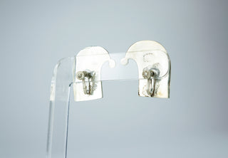 Designer: unknown (Taxco) Period: 1950s Dimensions: 1.25”x 75” Material: sterling, turquoise Condition: Very good  Resembling quotation marks, this pair of earrings features embedded turquoise fragments in silver. Screw back. Available at Fonfrege.com