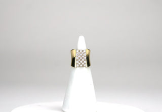 This elegant but understated ring features a square pavé of 23 round brilliant cut diamonds that sits like a buckle atop an 18K gold band. The band is countoured and narrows at the bottom. Approximately 0.65 carats total. 7.40 dwts. Available at fonfrege.com