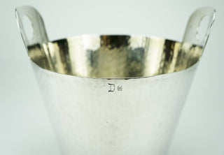 Calegaro was founded in 1921 and is one of Italy’s most famous silversmiths. This midcentury champagne bucket is hand-finished with hammered silverplate. Hallmarked at the rim. Very good condition with very minor wear.  Designer: Calegaro Period: Early 1960s Material: Silverplate Dimensions: 7”x 8” Condition: Very good. Available at fonfrege.com