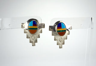Murray Jackson is an artisan within the Arizona Hualapai reservation. These bold shields have the geometric symmetry which Zuni design is famous for. The cabochons are finely detailed and individually framed in silver. Exceptionally fine workmanship. Please note these are stud earrings, not clips. Available at Fonfrege.com