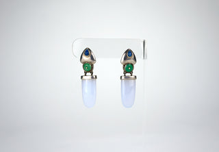 Designer: Unknown Period: 1980s Dimensions: 1.75” Material: chrysocolla, jade, and lapis Condition: Excellent  This sophisticated pair of 1980s earrings feature a drop pendant in luminous chrysocolla and centered with a jade circular bail. The pierced studs are faced in sterling with lapis teardrops. Stud earrings. Available at Fonfrege.com