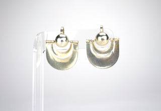 Designer: unknown (Taxco) Period: 1930s Dimensions: 1”x1” Material sterling Condition: Very good  A silver ball with two draping silver ribbon forms that swing, catching the light. Deceptively simple in design, these screw-back earrings are surprisingly light. Available at Fonfrege.com